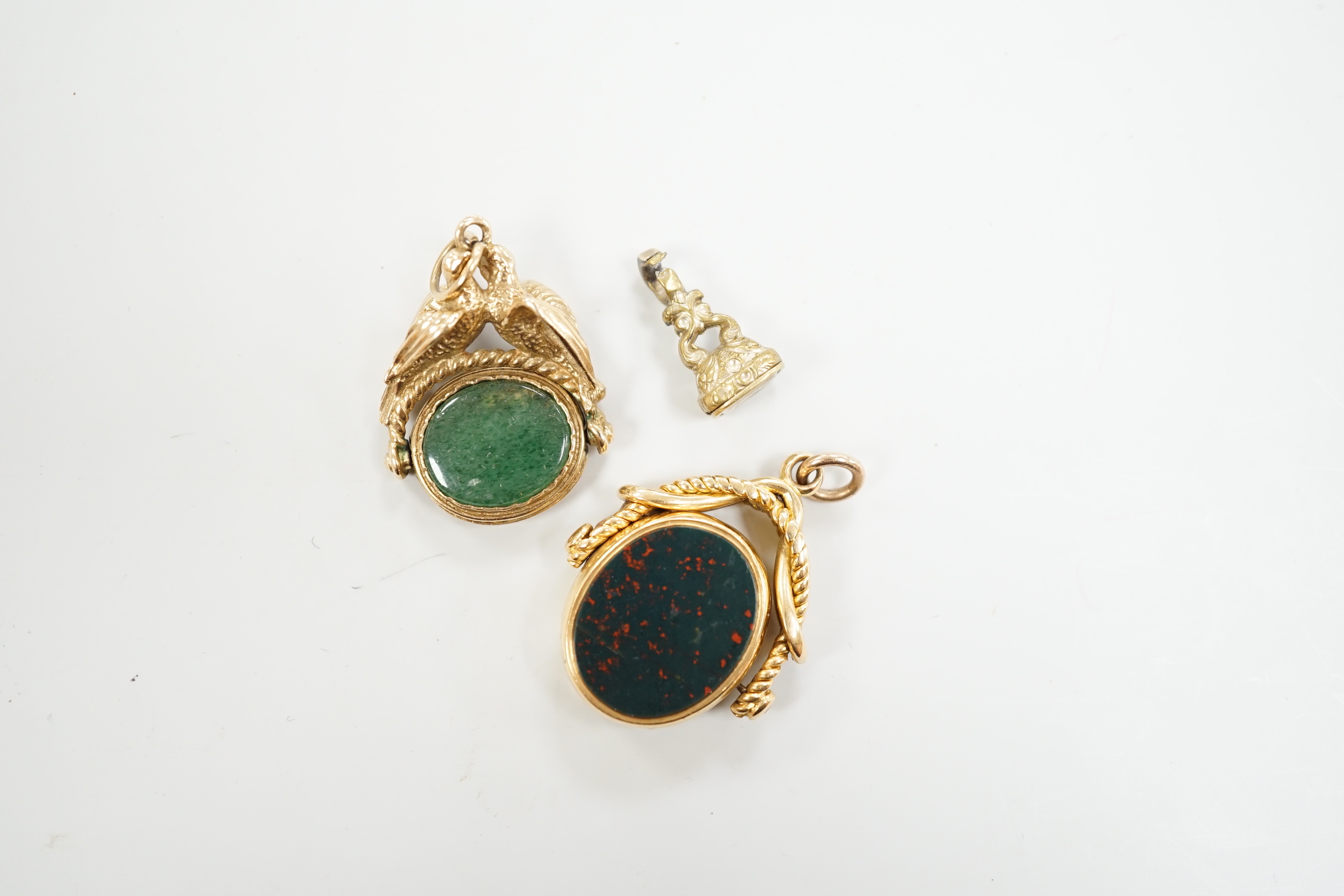 A Victorian 18ct gold and chalcedony set spinning fob, 30mm and two other fob seals including 9ct gold spinning fob.